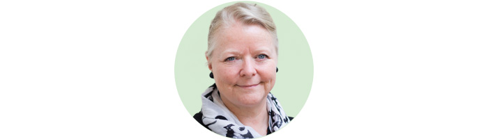 woman smiling at camera on mint green background